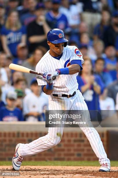 Addison Russell of the Chicago Cubs at bat against the Washington Nationals during game three of the National League Divisional Series at Wrigley...