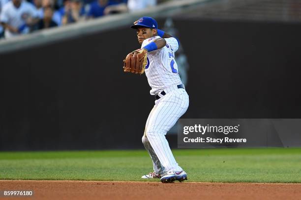 Addison Russell of the Chicago Cubs makes a throw to first base during game three of the National League Divisional Series against the Washington...