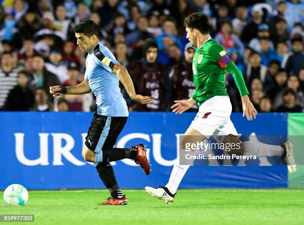 Luis Suarez of Uruguay runs after the ball while followed by Ronald Raldes of Bolivia during a match between Uruguay and Bolivia as part of FIFA 2018...