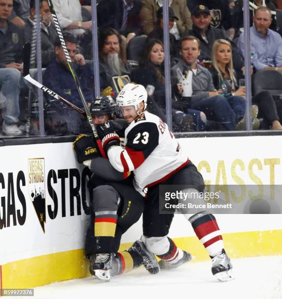 Tomas Nosek of the Vegas Golden Knights is hit into the boards by Oliver Ekman-Larsson of the Arizona Coyotes during the second period during the...