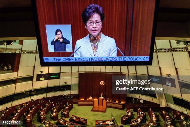 Hong Kong's Chief Executive Carrie Lam is shown on a live feed as she delivers her first policy address in the main chamber of the Legislative...