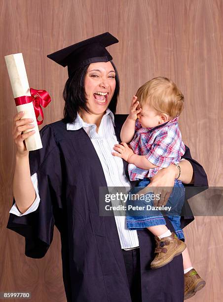 mature student graduation with baby. - parsons green stock pictures, royalty-free photos & images