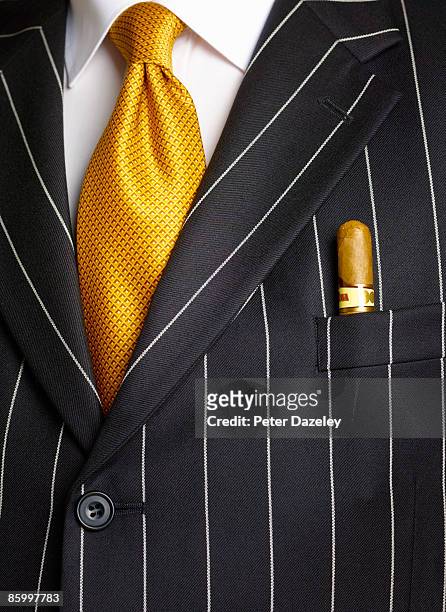 businessman with cigar in pocket. - fat cat stock pictures, royalty-free photos & images