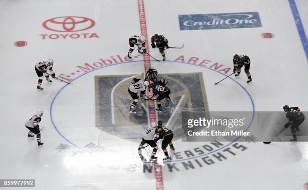 Derek Stepan of the Arizona Coyotes and Cody Eakin of the Vegas Golden Knights take the opening face off at the start of the Golden Knights'...