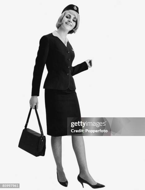 An air hostess in uniform, circa 1964.