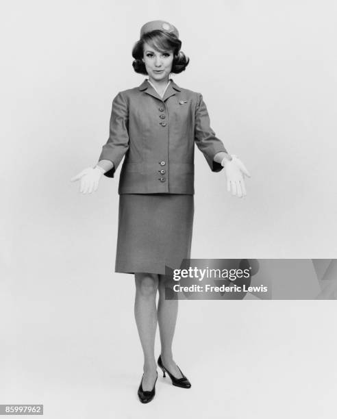 An air hostess in uniform, circa 1965.