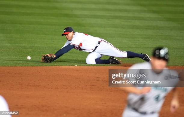 Second Baseman Kelly Johnson of the Atlanta Braves makes a diving attempt at a grounder against the Florida Marlins at Turner Field on April 15, 2009...