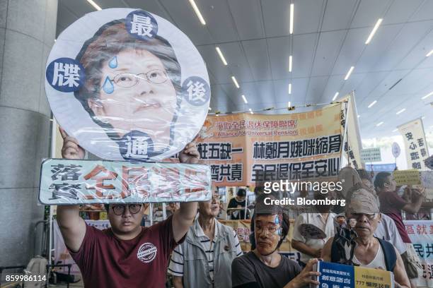 Protesters hold placards and shout slogans ahead of Hong Kong's Chief Executive Carrie Lam's policy address outside of the Legislative Council in...