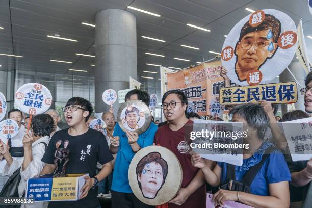 Protesters hold placards and shout slogans ahead of Hong Kong's Chief Executive Carrie Lam's policy address outside of the Legislative Council in...