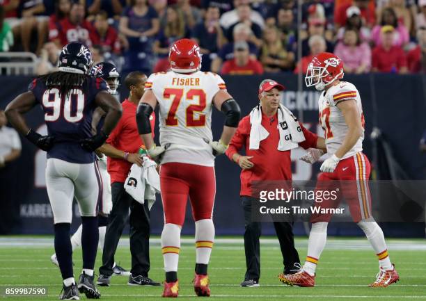 Travis Kelce of the Kansas City Chiefs is tended to by the training staff after an injury in the second quarter against the Houston Texans at NRG...