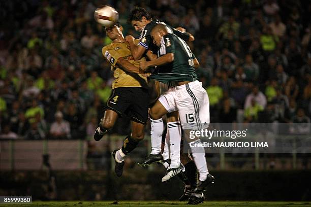 Durval of Sport, vies for the ball with Edmilson and Mauricio Ramos , of Palmeiras, during their 2009 Libertadores Cup football match held at...