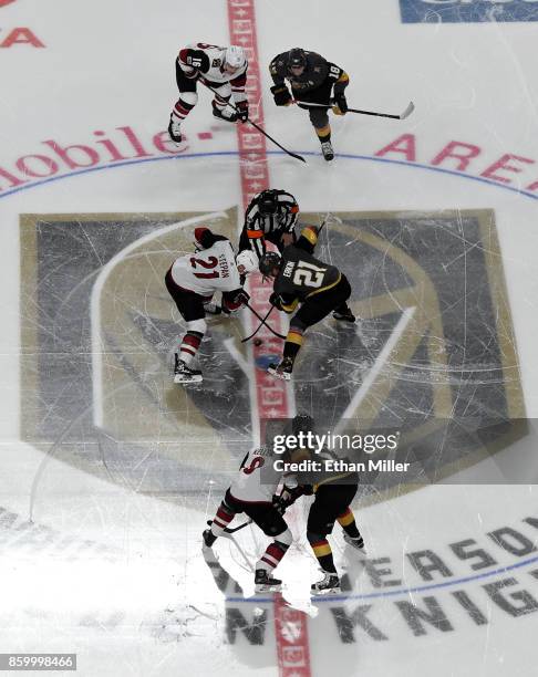 Derek Stepan of the Arizona Coyotes and Cody Eakin of the Vegas Golden Knights take the opening face off at the start of the Golden Knights'...