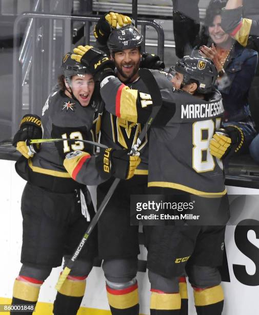 Deryk Engelland of the Vegas Golden Knights celebrates with teammates Brendan Leipsic and Jonathan Marchessault after Engelland scored a first-period...
