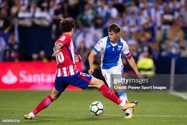 Alexander Szymanowski of CD Leganes fights for the ball with Sime Vrsaljko of Atletico de Madrid during the La Liga 2017-18 match between CD Leganes...