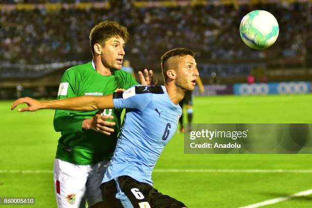 Ronald Raldes and Uruguay's Rodrigo Bentancur vie for the ball during the 2018 FIFA World Cup Qualification match between Uruguay and Bolivia at...