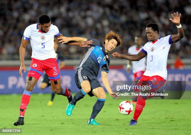 Yuya Osako of Japan controls the ball under pressure of Haiti defense during the international friendly match between Japan and Haiti at Nissan...