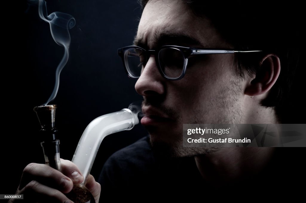 Young man smoking drugs