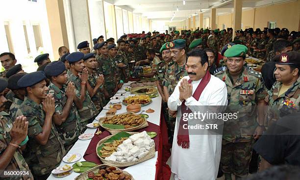 Sri Lankan President Mahinda Rajapakse gestures as he greets troops during a visit to the city of Kilinochchi on April 16, 2009. Rajapakse visited...