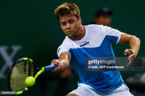 Ryan Harrison of the US hits a return during the men's singles against Grigor Dimitrov of Bulgaria at the Shanghai Masters tennis tournament in...