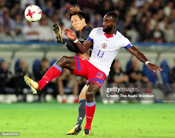 Yuki Kobayashi of Japan and Kevin Pierre Lafrance of Haiti compete for the ball during the international friendly match between Japan and Haiti at...