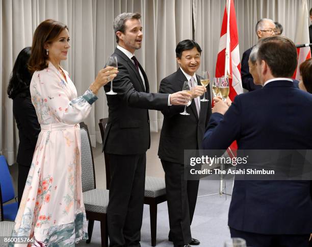 Crown Prince Frederik of Denmark, Crown Princess Mary of Denmark and Japanese Crown Prince Naruhito toast glasses at a reception at the National...