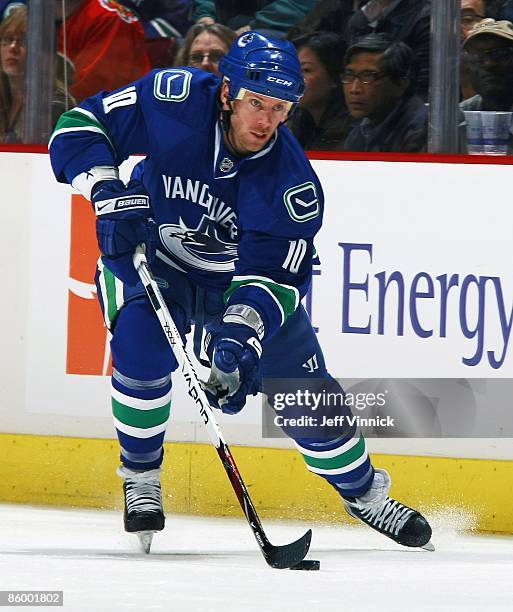 Ryan Johnson of the Vancouver Canucks skates up ice with the puck during the game against the Calgary Flames at General Motors Place on April 7, 2009...