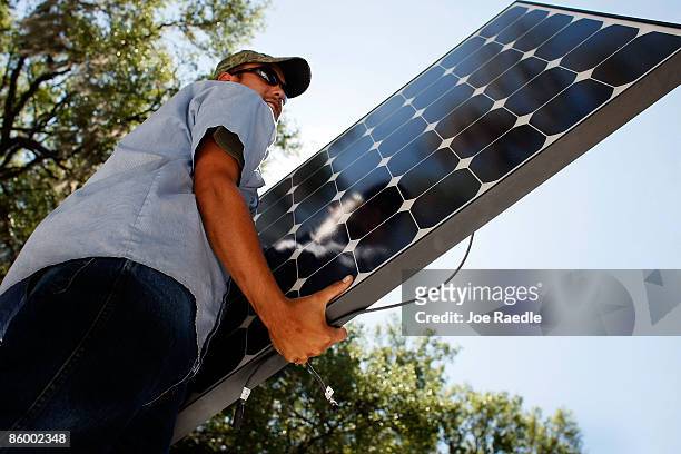 Damon Corkern who works for ECS Solar Energy Systems, Inc, installs a solar panel system on the roof of a home on April 16, 2009 in Gainesville,...