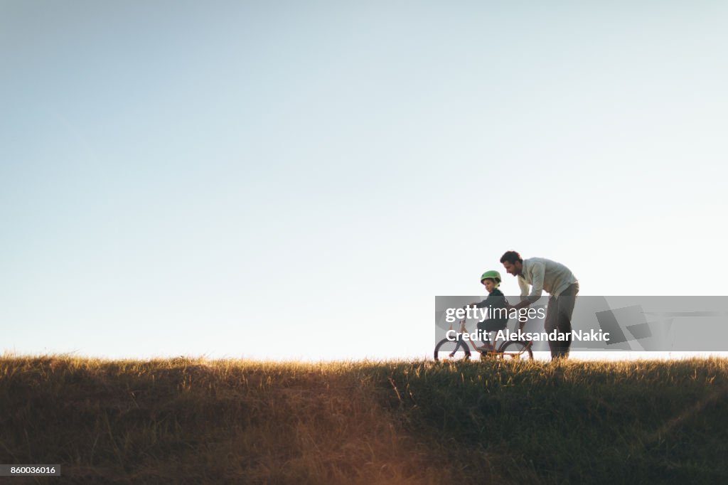 Father and son on a bicycle lane