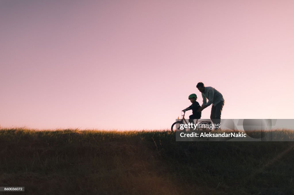 Father and son on a bicycle lane