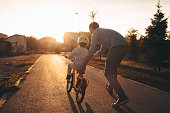 Father and son on a bicycle lane