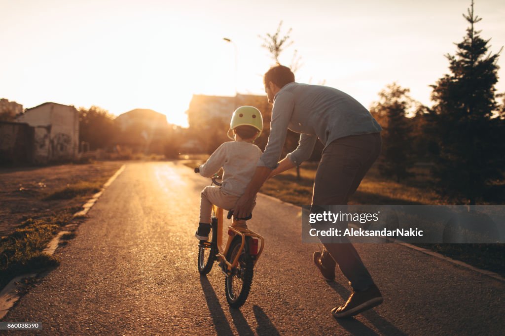 Father and son on a bicycle lane