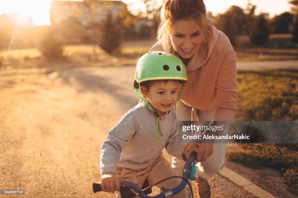 Mother and son on a bicycle lane