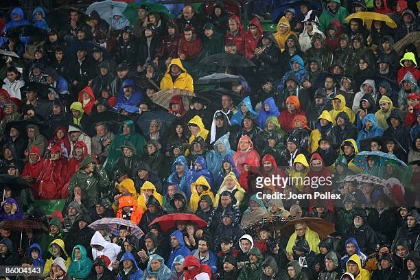 Fans of Udinese in rain suites are seen during the UEFA Cup quarter final second leg match between Udinese Calcio and SV Werder Bremen at Stadio...