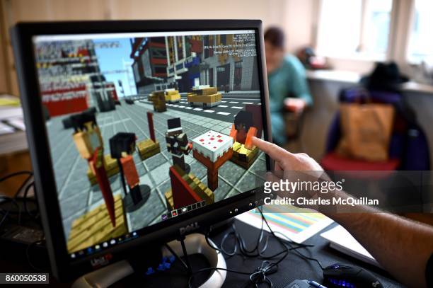 Minecraft digital artist points at the digital version of the character 'Sal' as they work backstage during a 'Playcraft' live rehearsal at The...