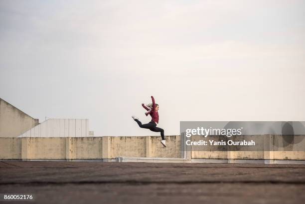 female ballet dancer dancing on a rooftop in lyon, france - street dancers stock pictures, royalty-free photos & images