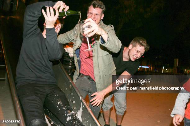 friends celebrating new years eve at playground - drunk stockfoto's en -beelden