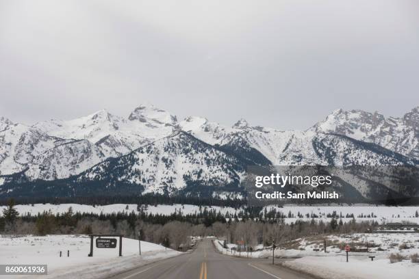 Empty Road with views of the Grand Teton National Park in Wyoming, United States of America.