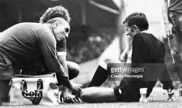 English League Division One match at Anfield, Liverpool 0 v Aston Villa 0.Liverpool coach Ronnie Moran attends to the referee who has gone down with...
