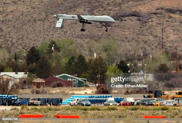 An MQ-1B Predator unmanned aircraft system descends while practicing touch-and-go landings during a training flight April 16, 2009 at Creech Air...