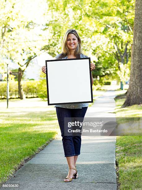 girl with sign in suburbs - person holding blank sign fotografías e imágenes de stock