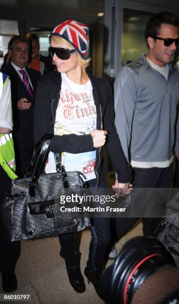 Paris Hilton and Doug Reinhardt arrive at Heathrow Airport en-route to the USA on April 17, 2009 in London, England.