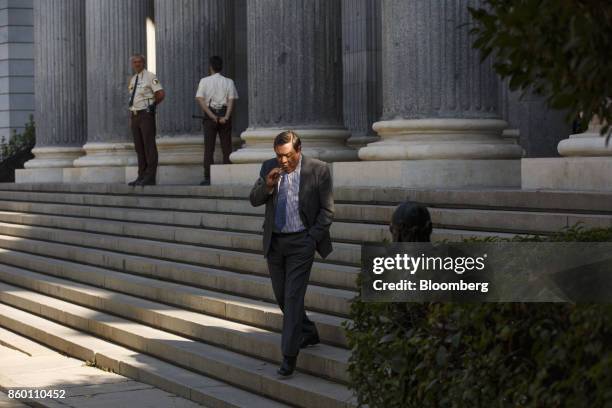 Visitors passes security guards at the entrance to the Madrid Stock Exchange, also known as Bolsa de Madrid, in Madrid, Spain, on Wednesday, Oct. 11,...