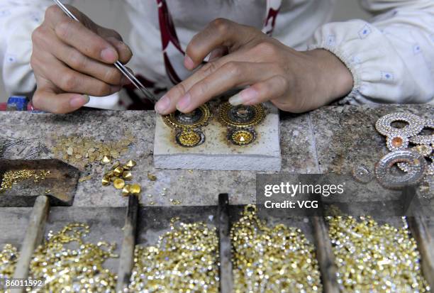 Neoglory Jewelry Company worker processes jewelry on April 16, 2009 in Yiwu of Zhejiang Province, China. The Neoglory Jewelry Company is the leading...