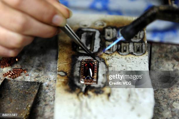 Neoglory Jewelry Company worker processes jewelry on April 16, 2009 in Yiwu of Zhejiang Province, China. The Neoglory Jewelry Company is the leading...