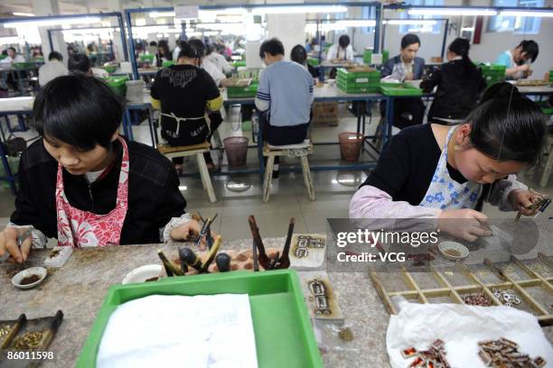 Neoglory Jewelry Company workers process jewelry on April 16, 2009 in Yiwu of Zhejiang Province, China. The Neoglory Jewelry Company is the leading...