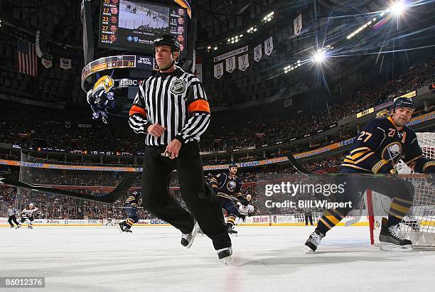 Referee Gord Dwyer watches the play between the Buffalo Sabres and the Boston Bruins on April 11, 2009 at HSBC Arena in Buffalo, New York.