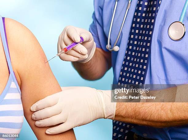 teenager receiving contraceptive injection. - studio shot stockfoto's en -beelden