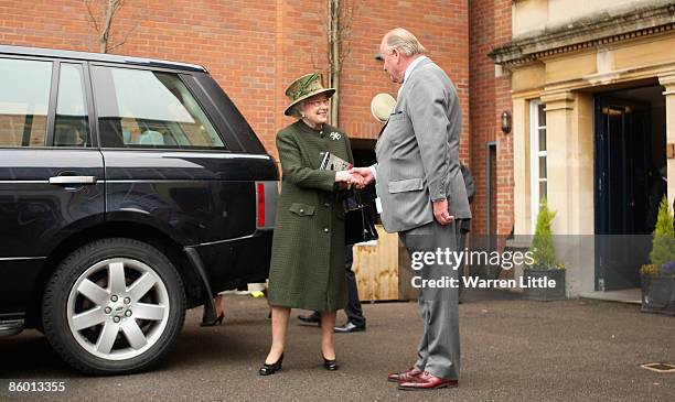 Queen Elizabeth II shakes hands with Christopher Spence at Newbury Racecourse on April 17 in Newbury, England.