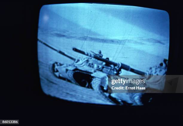 Picture of two tanks advancing across a desert landscape, September 1975.