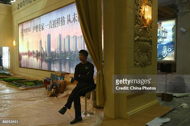 Workers install an exhibition area for a local real estate fair on April 17 in Wenzhou of Zhejiang Province, China. According to the National Bureau...